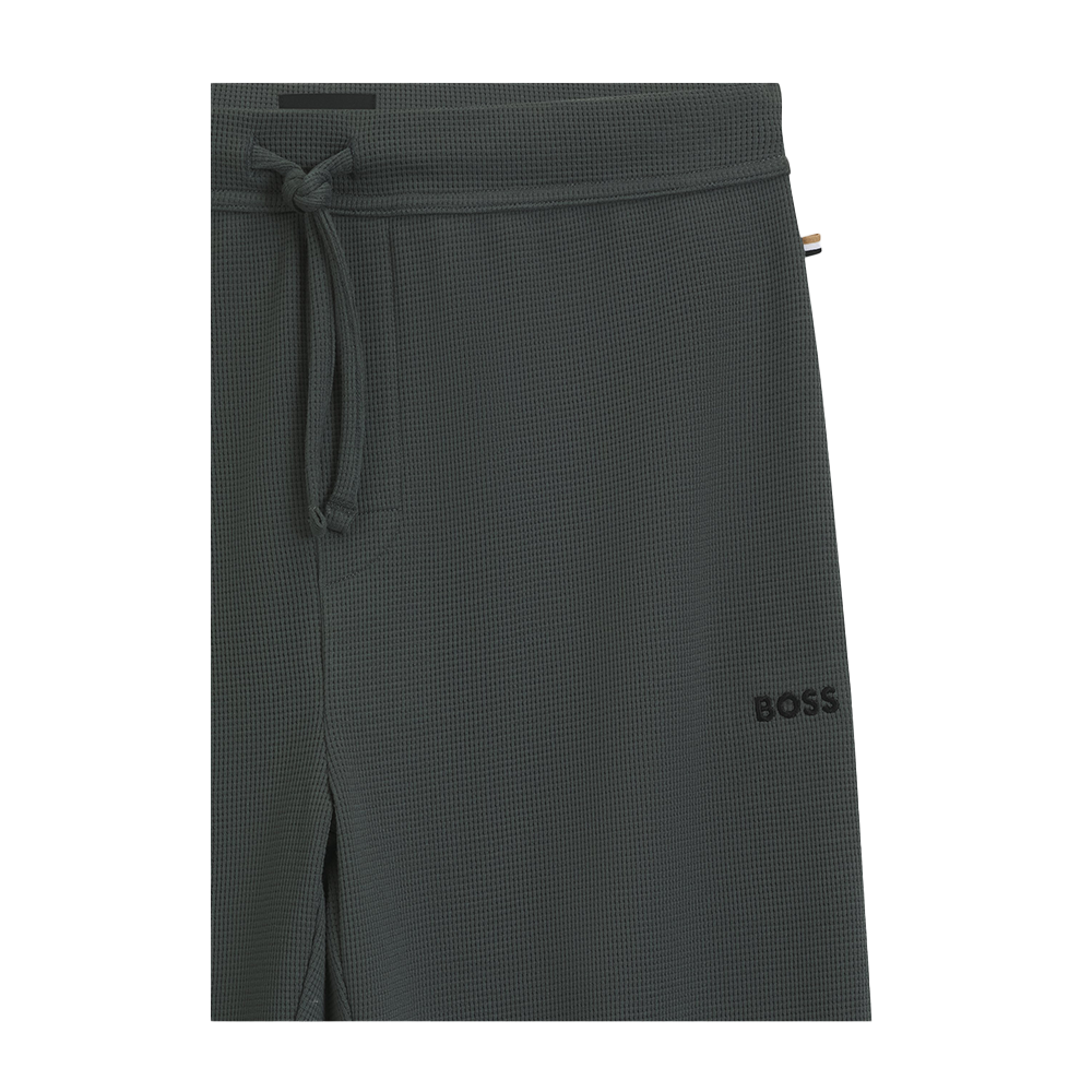 Dark green textured lounge pants with a brand logo on a white background