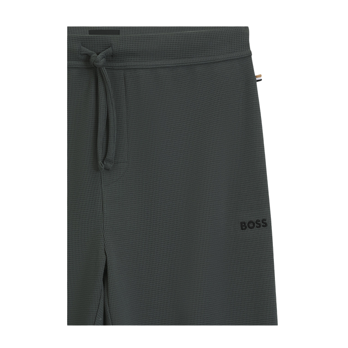 Dark green textured lounge pants with a brand logo on a white background