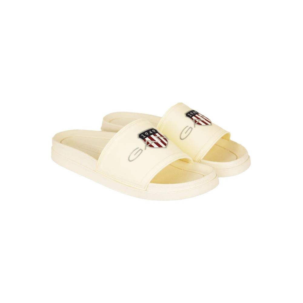 Pair of cream-colored slides with a logo on a white background