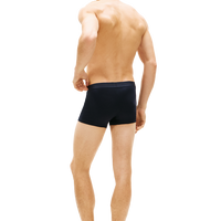 man wearing tommy hilifiger navy boxer trunks