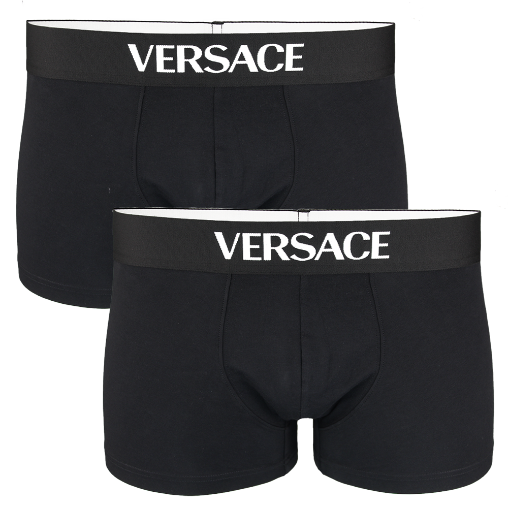 Two black Versace boxer trunks on a white background