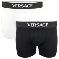 Two pairs of Versace boxer briefs, one black and one white, on a white background.