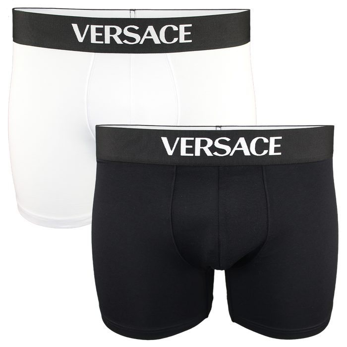 Two pairs of Versace boxer briefs, one black and one white, on a white background.