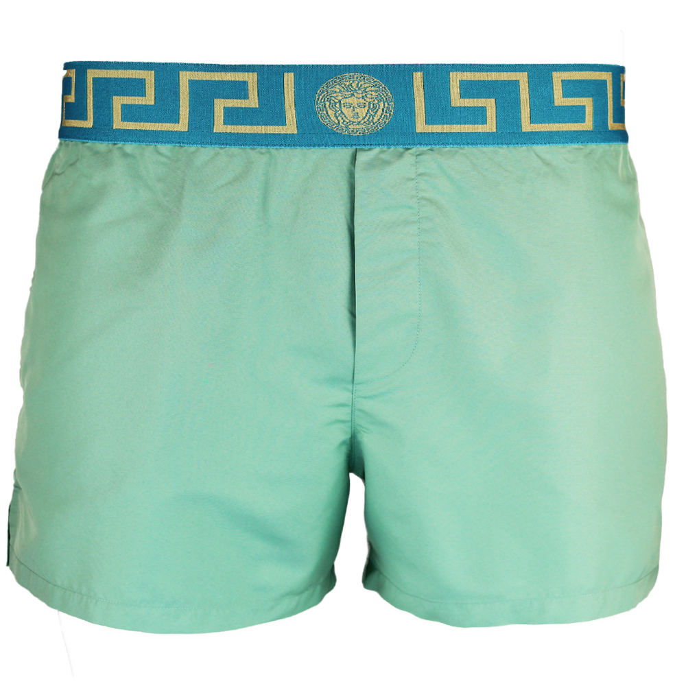 Green swim shorts with a decorative blue and gold waistband on a white background