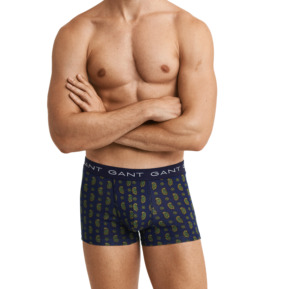 Man wearing GANT patterned boxer trunks on a white background
