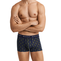 Man wearing GANT patterned boxer trunks on a white background