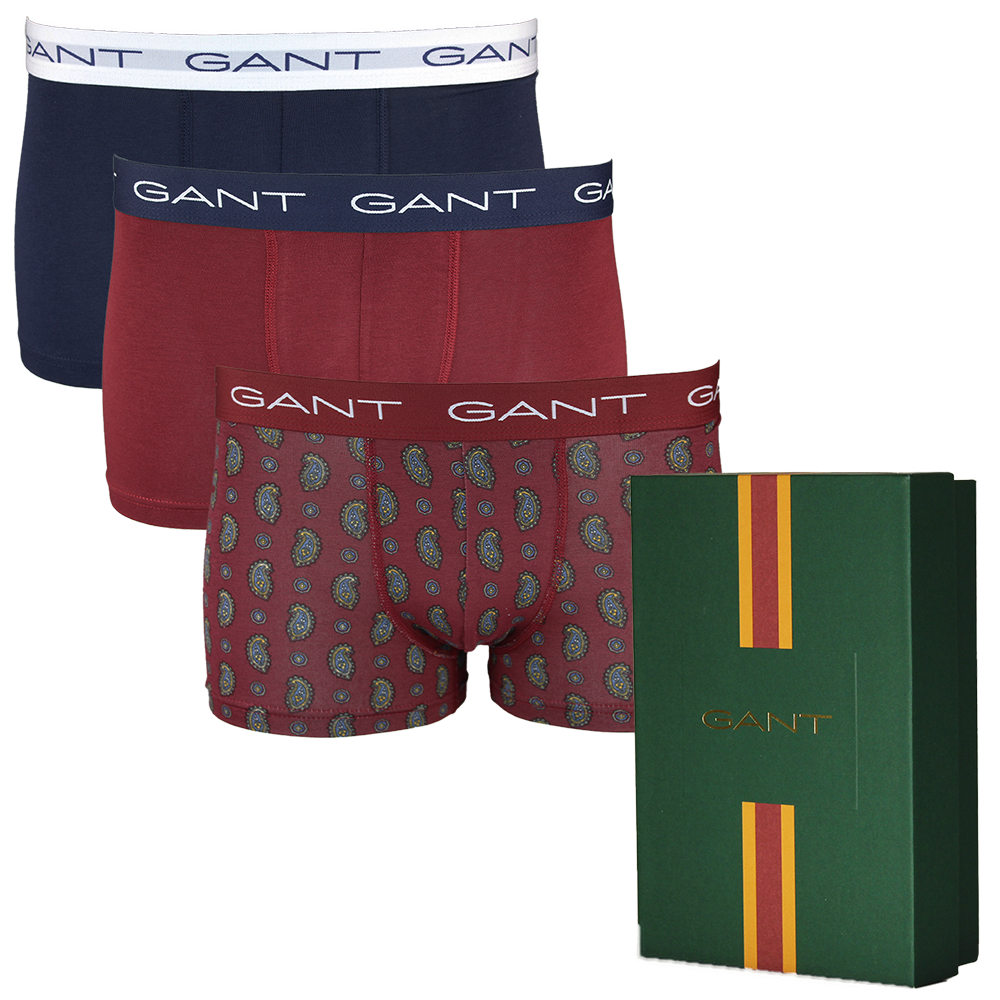 Three pairs of Gant boxer trunks in different colors with a green box featuring Gant branding.