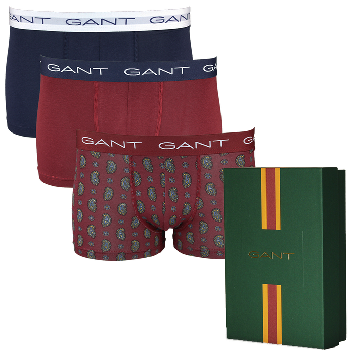 Three pairs of Gant boxer trunks in different colors with a green box featuring Gant branding.