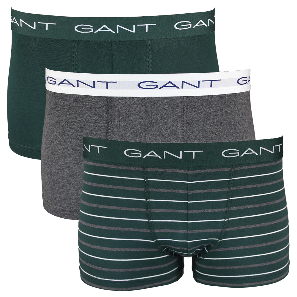 Three pairs of GANT boxer trunks in green, gray, and striped design on a white background.