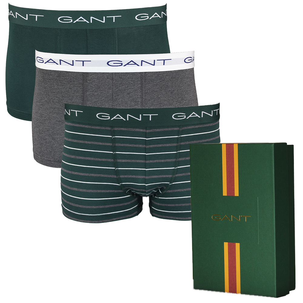 Three pairs of Gant boxer trunks in different styles with a Gant branded box on a white background.