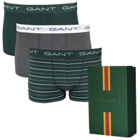 Three pairs of Gant boxer trunks in different styles with a Gant branded box on a white background.