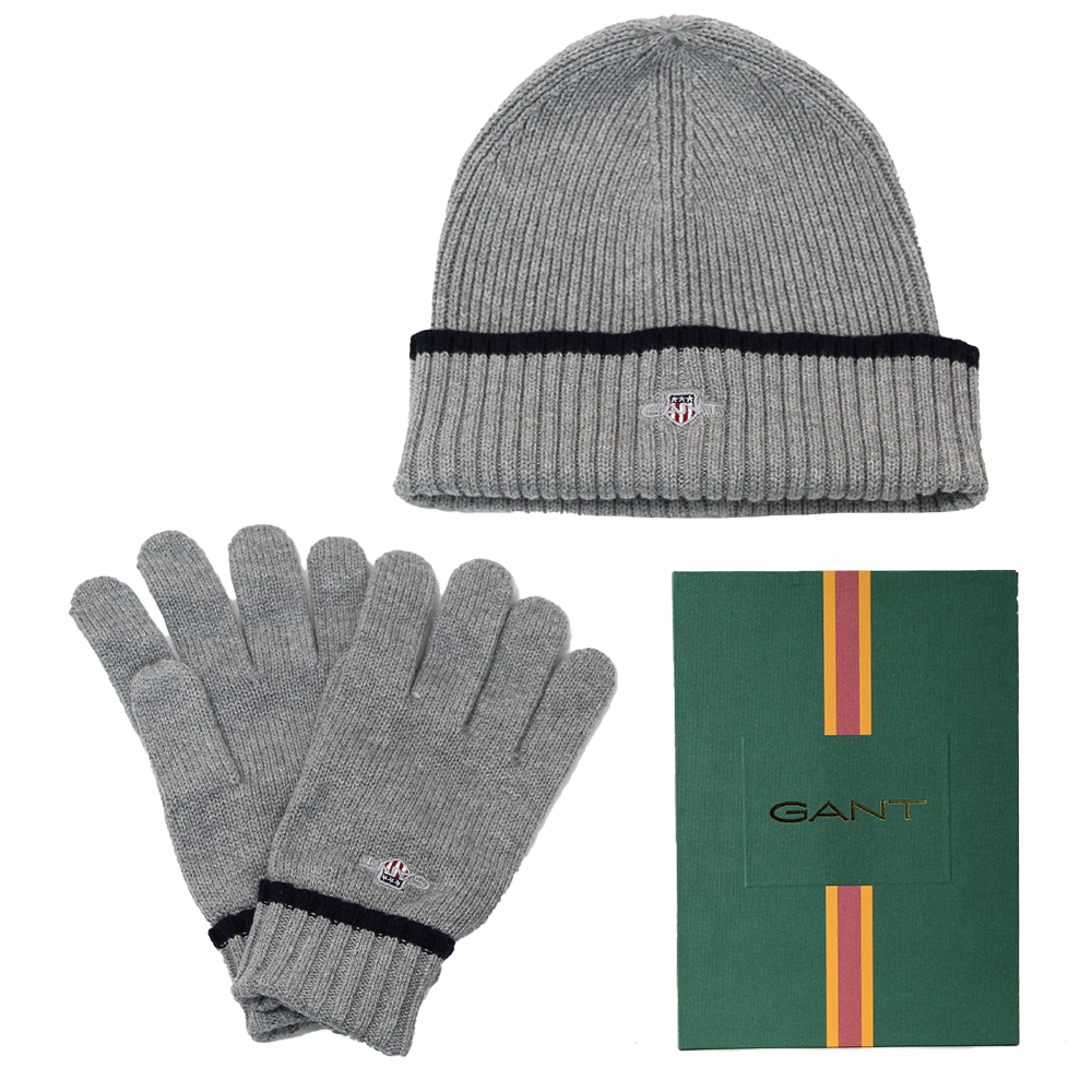 Gray knit beanie and gloves set with GANT logo, including a green box with GANT branding.