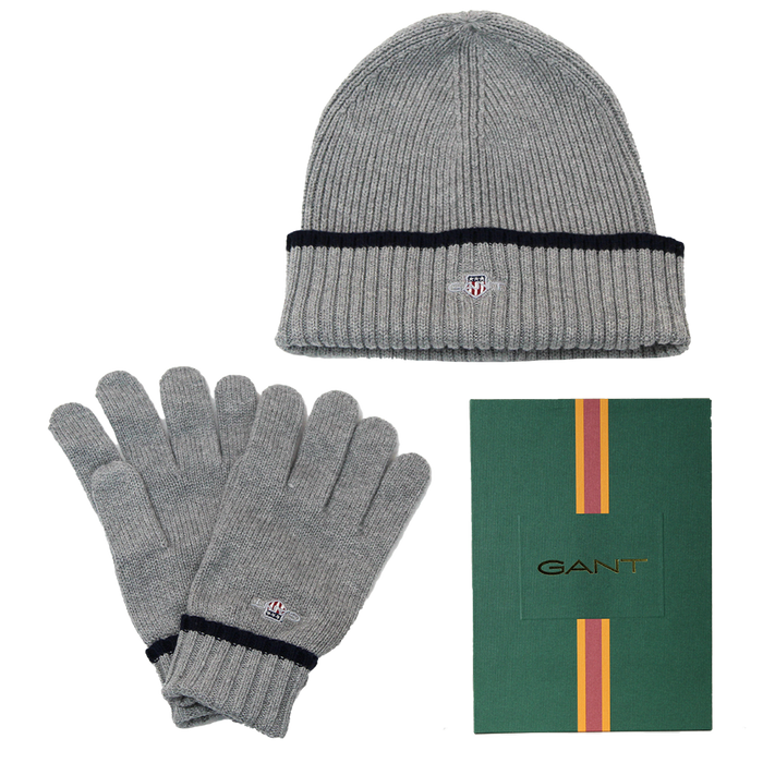 Gray knit beanie and gloves set with GANT logo, including a green box with GANT branding.