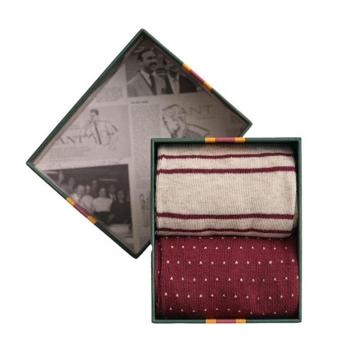 Two pairs of patterned Gant socks in a decorative box with vintage-style newspaper background