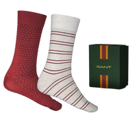 Two pairs of socks with red and white patterns next to a Gant box on a white background