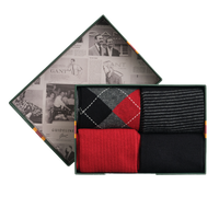Set of three socks in a decorative box with a newspaper design on the lid.