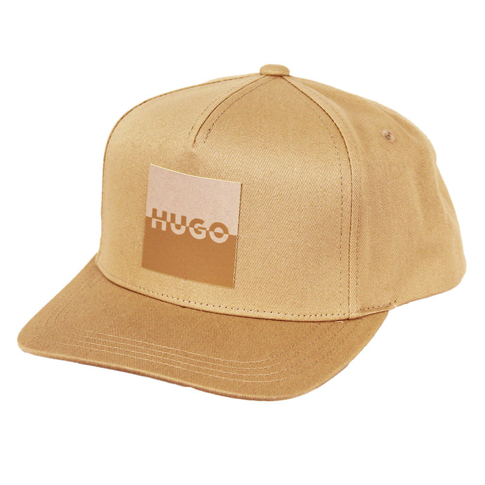 Beige cap with a patch displaying 'HUGO' on a white background