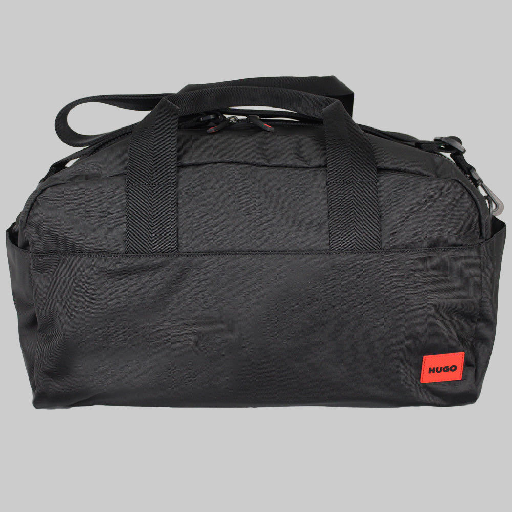Black duffel bag with a red Hugo label on a white background