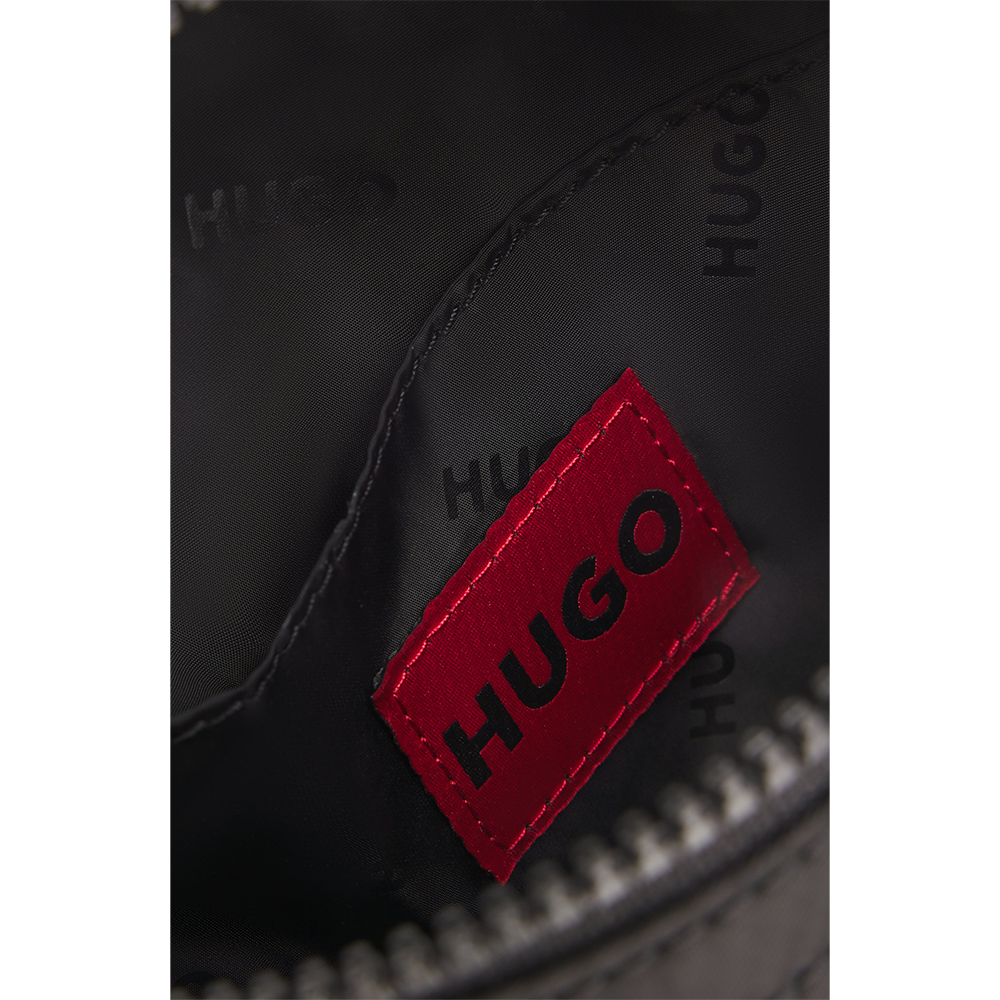 Close-up of a black bag with a red 'HUGO' logo on a white background