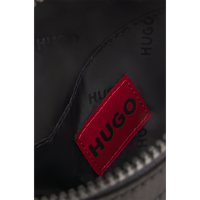 Close-up of a black bag with a red 'HUGO' logo on a white background