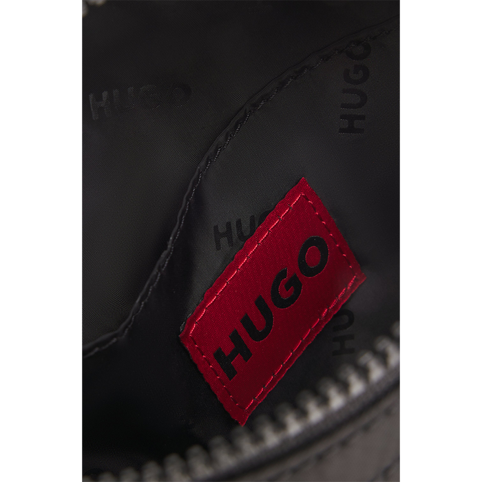 Close-up of a black bag with a red 'HUGO' logo on a white background