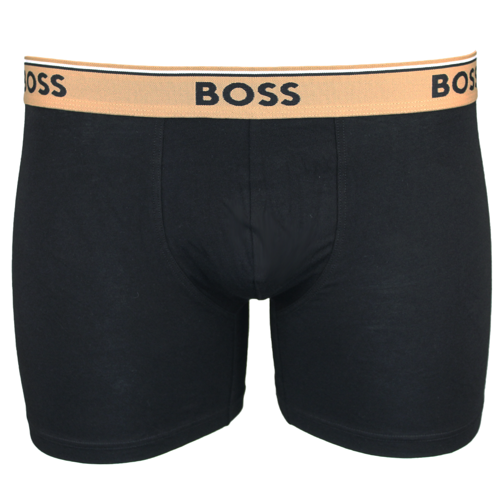 Black boxer briefs with a beige waistband featuring 'BOSS' branding on a white background.