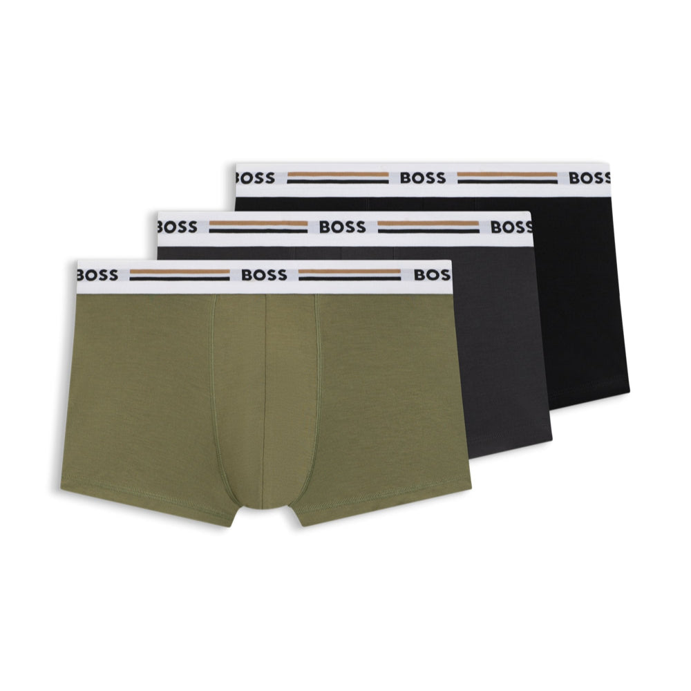 A set of three multicolored boxer trunks, including one in green, one in black, and one in a dark color, all with the BOSS brand waistbands.