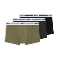 A set of three multicolored boxer trunks, including one in green, one in black, and one in a dark color, all with the BOSS brand waistbands.