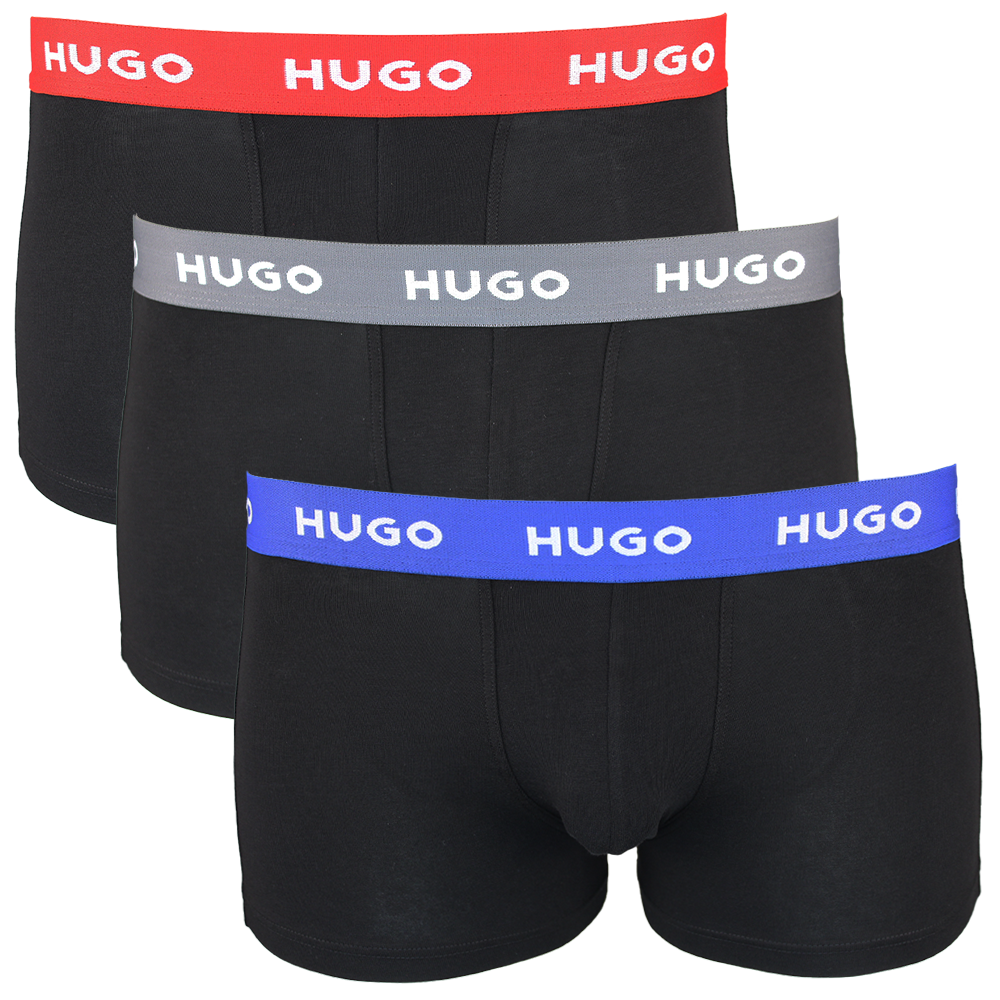 Three black boxer trunks with colorful 'HUGO' brand bands on a white background