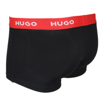 Black boxer trunk with a red waistband featuring 'HUGO' branding on a white background.