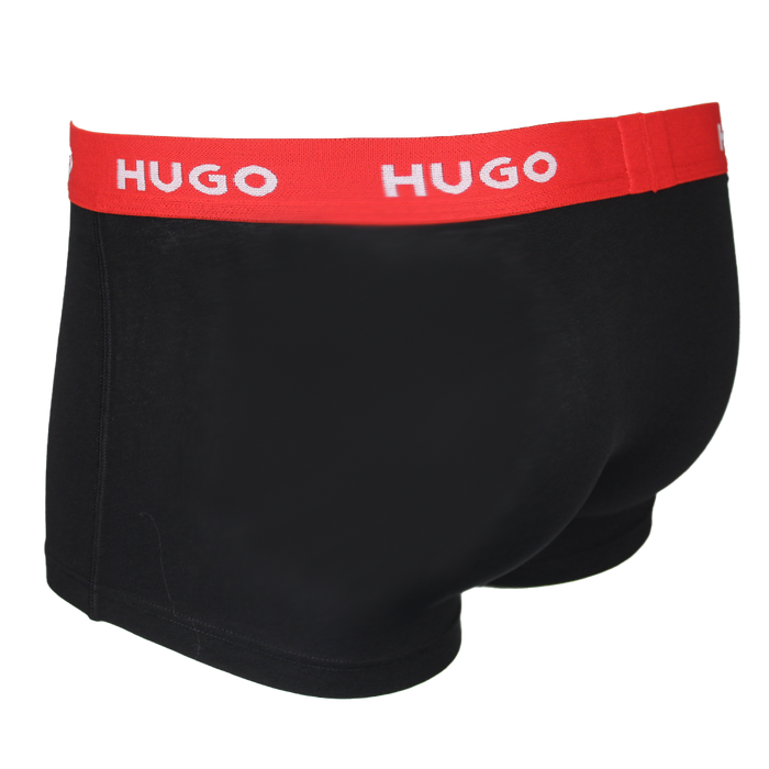 Black boxer trunk with a red waistband featuring 'HUGO' branding on a white background.