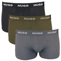 Three pairs of HUGO boxer trunks in black, green, and gray on a white background.