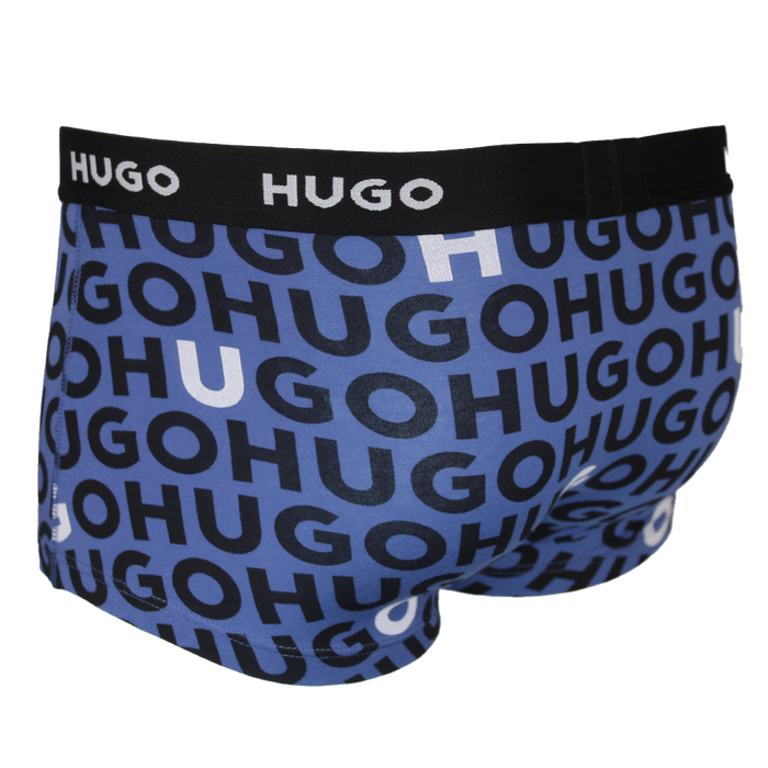Blue boxer trunks with black 'HUGO' logo pattern on a white background