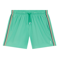Green swim shorts with striped side panels on a white background