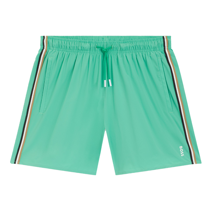 Green swim shorts with striped side panels on a white background