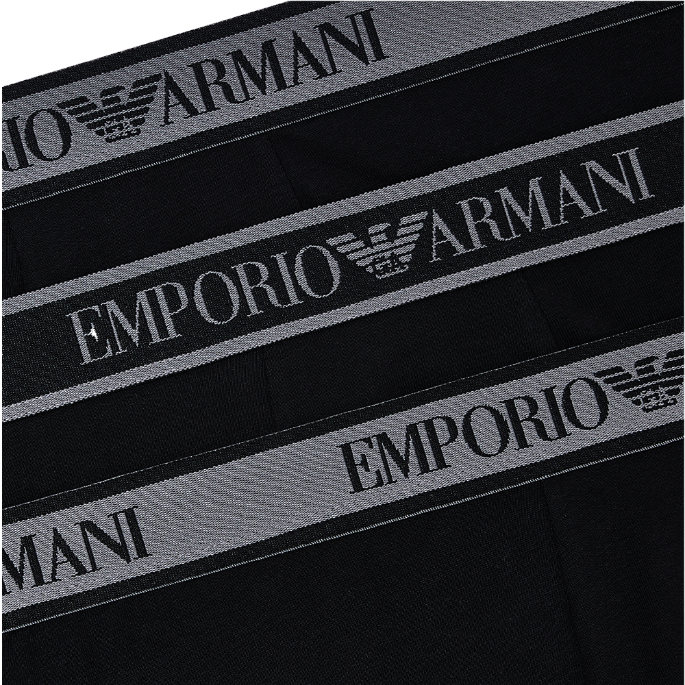 a model wearing Emporio Armani boxer trunk, black waistband detail