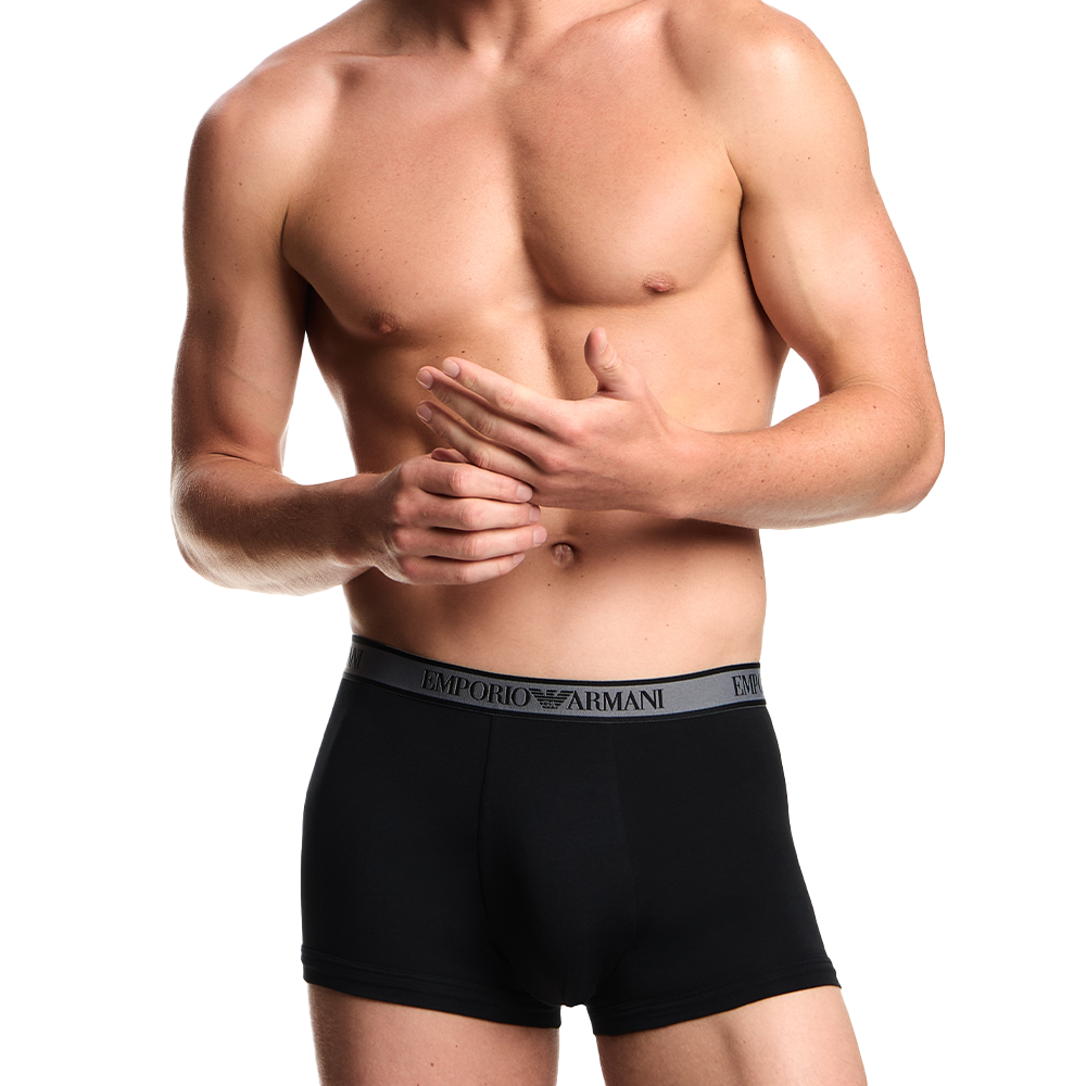 a model wearing Emporio Armani boxer trunks black with contrast waistband