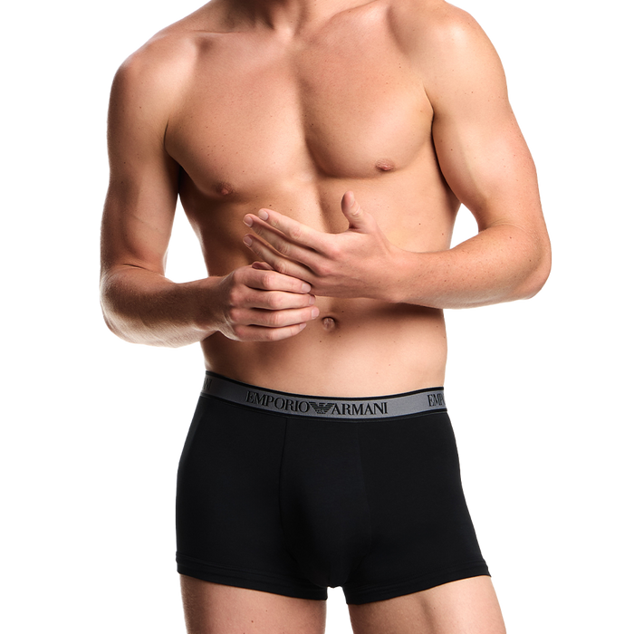 a model wearing Emporio Armani boxer trunks black with contrast waistband