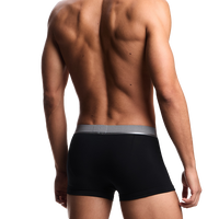 back view of a model wearing black Armani boxer trunks with branded silver waistband