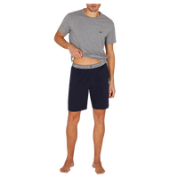 Man wearing a gray t-shirt and navy shorts on a white background