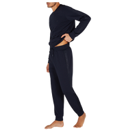 Person wearing a navy tracksuit on a white background