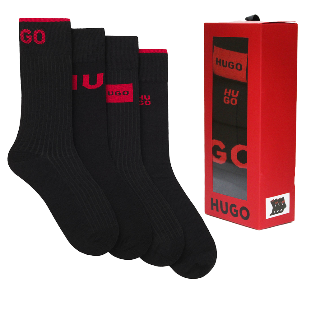 Set of black socks with red branding next to a red HUGO box on a white background