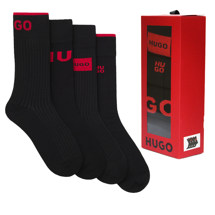 Set of black socks with red branding next to a red HUGO box on a white background