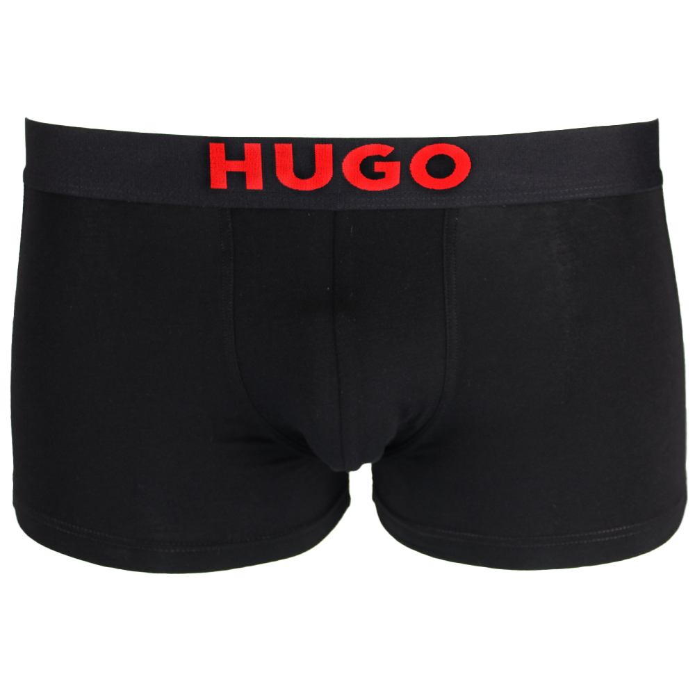 Black boxer trunks with red 'HUGO' waistband on a white background