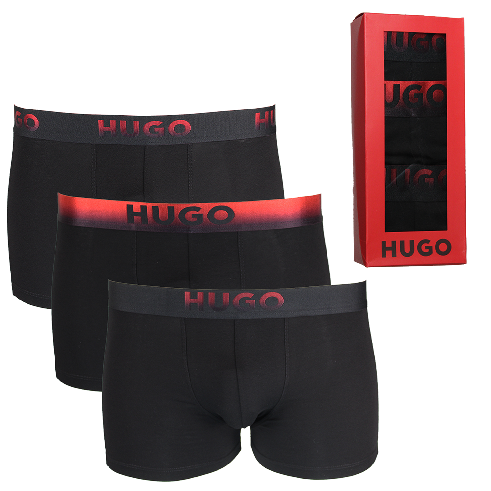 Three black boxer briefs with red 'HUGO' waistbands and a red 'HUGO' branded box on a white background.