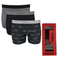 Three pairs of Hugo boxer briefs in black and gray with a red box on a white background.