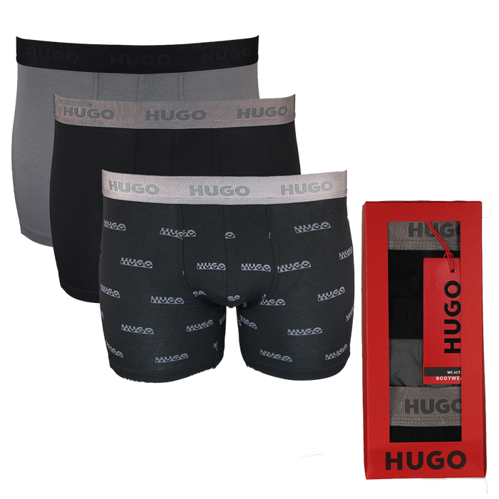 Three pairs of Hugo boxer briefs in black and gray with a red box on a white background.