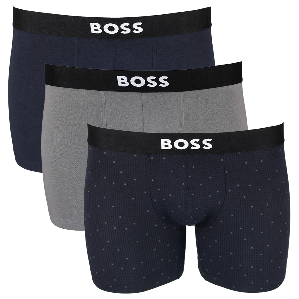 Three pairs of BOSS boxer briefs in navy, gray, and patterned navy with black waistbands.