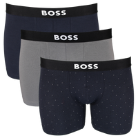 Three pairs of BOSS boxer briefs in navy, gray, and patterned navy with black waistbands.