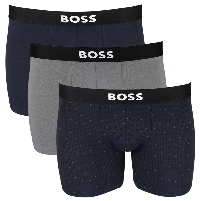 Three pairs of BOSS boxer briefs in navy, gray, and patterned navy with black waistbands.